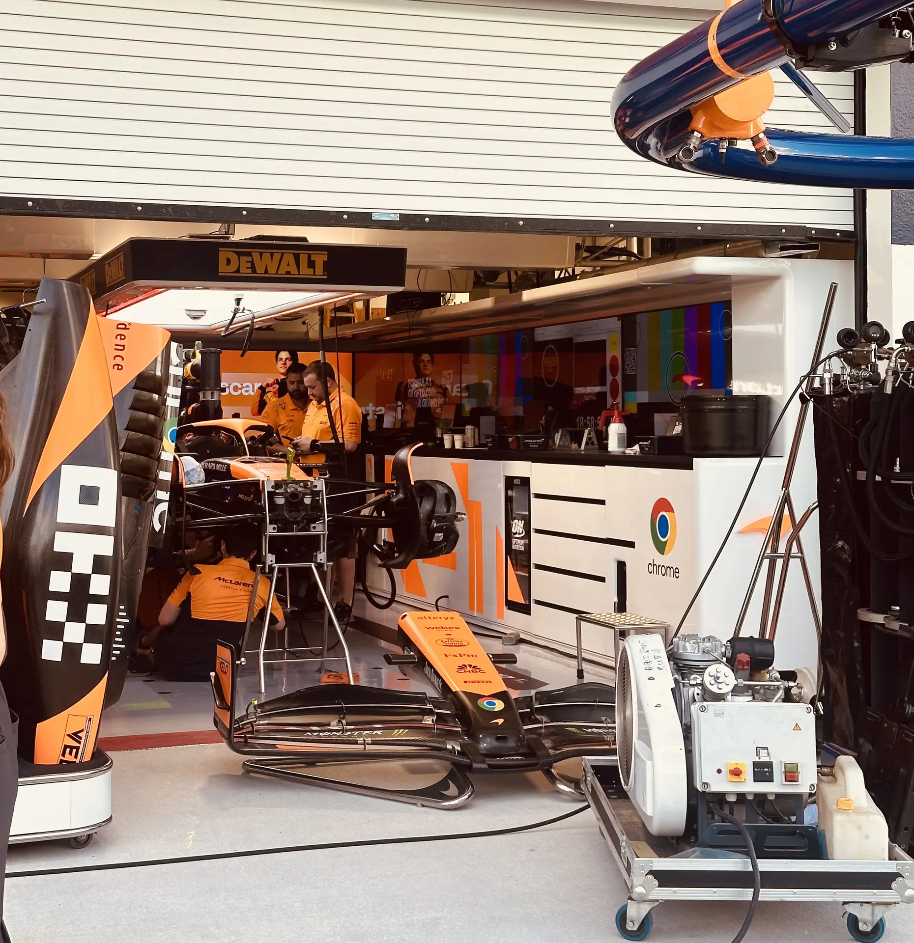 McLaren Formula 1 team prepping the car in the garage.